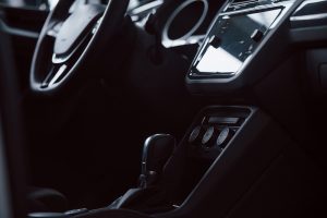 Gear stick. Front part of brand new automobile. Modern black interior. Conception of vehicles.