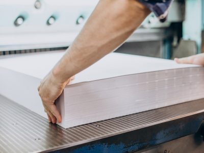 Man working in printing house with paper and paints